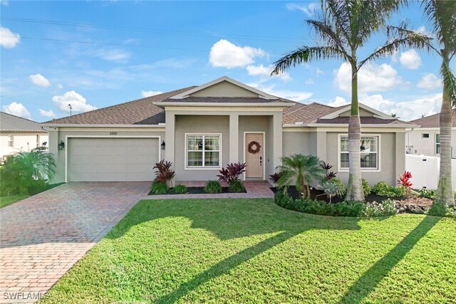 ranch-style home featuring a garage and a front yard