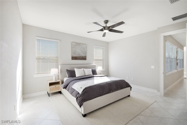 tiled bedroom featuring ceiling fan