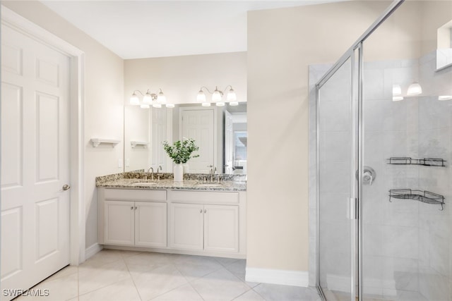 bathroom featuring tile patterned floors, walk in shower, and vanity