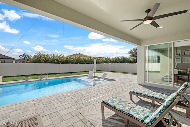 view of swimming pool with ceiling fan and a patio area