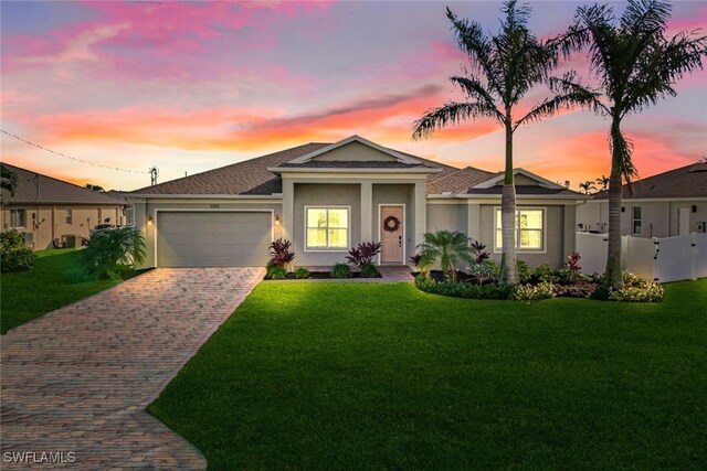 single story home with a lawn and a garage