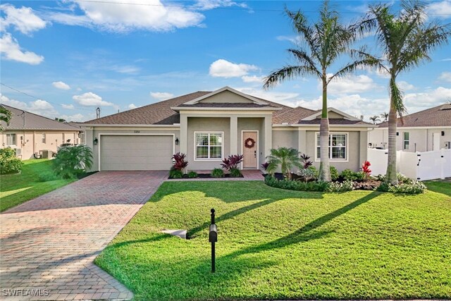 view of front of home featuring a garage and a front lawn