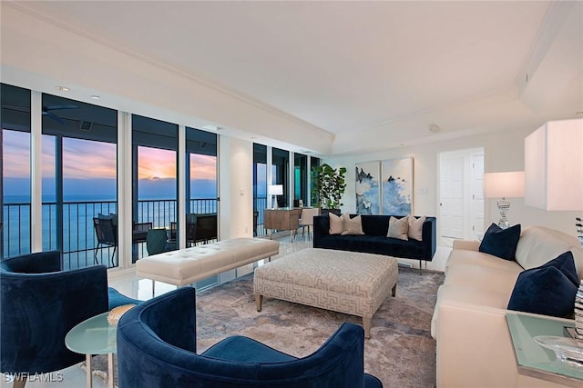 living room featuring a water view and a wall of windows