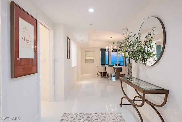 corridor featuring tile patterned flooring, a notable chandelier, recessed lighting, and baseboards