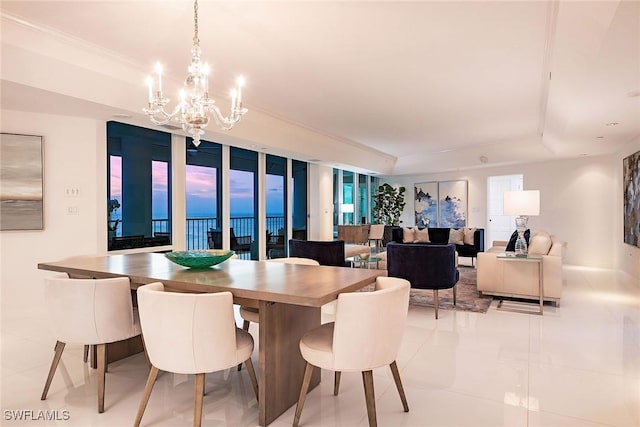 dining space with a tray ceiling and a chandelier