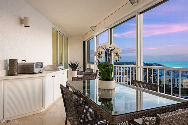 sunroom / solarium featuring visible vents, a water view, and a toaster