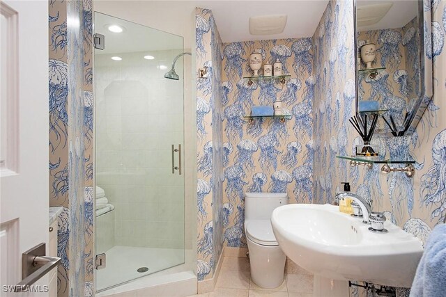 bathroom featuring toilet, a sink, recessed lighting, a shower stall, and tile patterned flooring