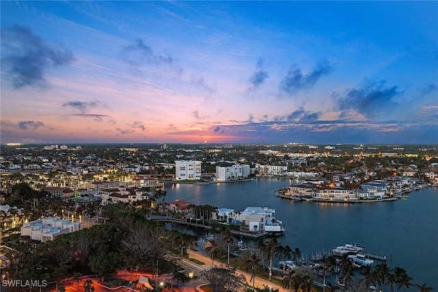 aerial view at dusk with a view of city and a water view