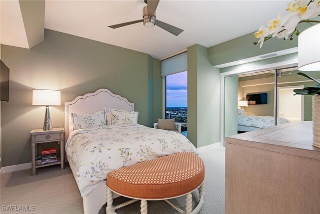 bedroom featuring baseboards, a ceiling fan, and carpet flooring