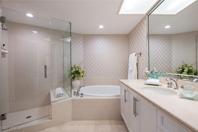 bathroom with recessed lighting, a shower stall, tile patterned flooring, a bath, and vanity