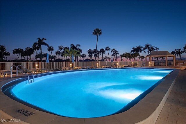 community pool with a gazebo and fence