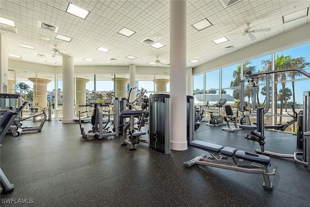 gym featuring plenty of natural light, a ceiling fan, and visible vents