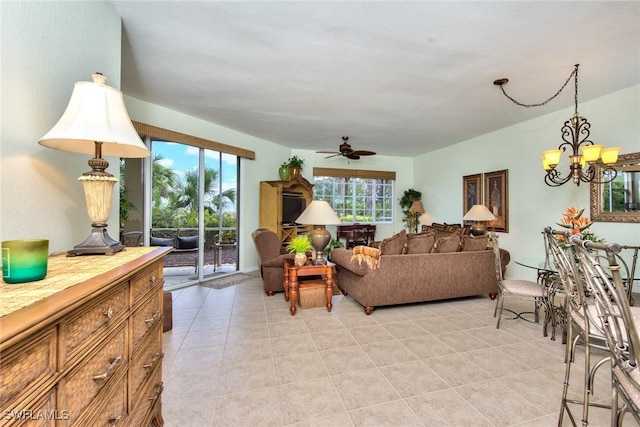 living room with ceiling fan with notable chandelier and light tile patterned flooring