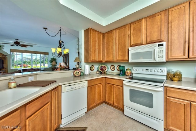 kitchen with light tile patterned floors, ceiling fan with notable chandelier, hanging light fixtures, and white appliances