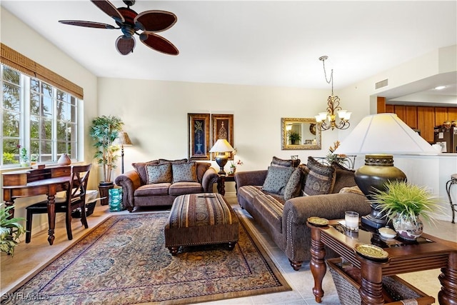 living room featuring visible vents and ceiling fan with notable chandelier