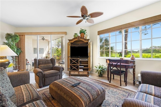 living room featuring ceiling fan and baseboards