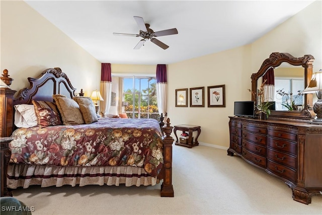 bedroom featuring baseboards, a ceiling fan, and light colored carpet