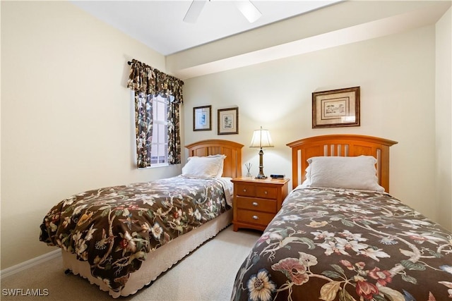 carpeted bedroom featuring ceiling fan and baseboards