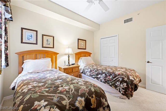 carpeted bedroom featuring a ceiling fan, baseboards, visible vents, and a closet