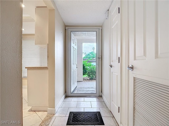 entryway featuring a textured ceiling and light tile patterned floors