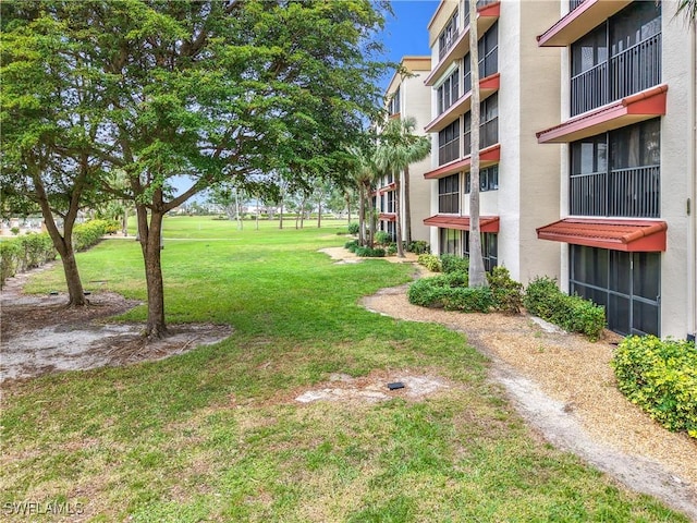 view of home's community with a lawn