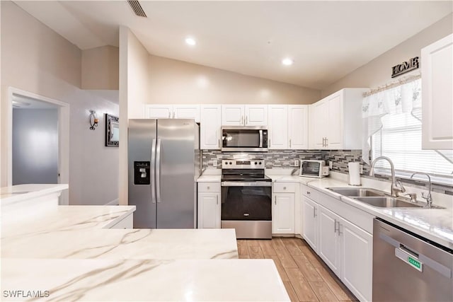 kitchen with stainless steel appliances and white cabinetry