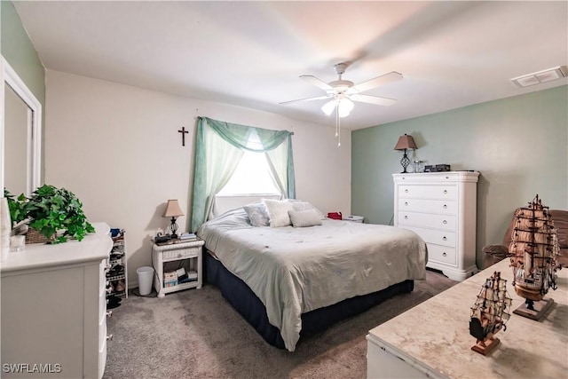 bedroom with ceiling fan and dark colored carpet