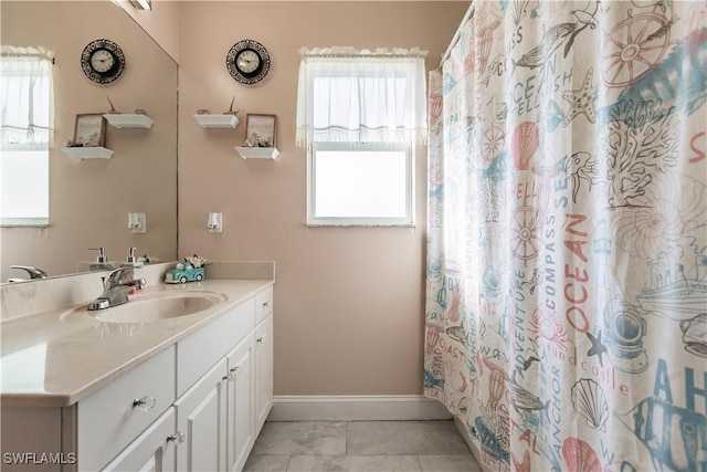 bathroom featuring tile patterned flooring and vanity