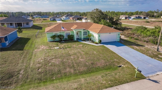 view of front of home featuring a garage and a front yard