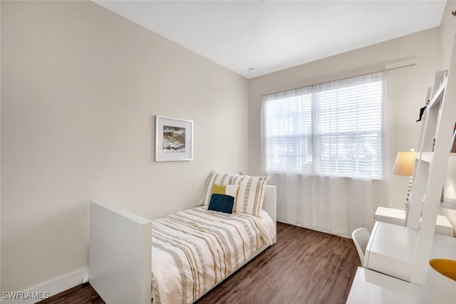 bedroom featuring dark hardwood / wood-style flooring