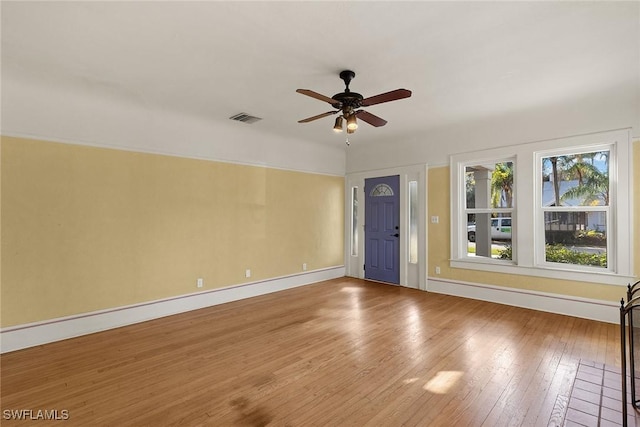 unfurnished room with ceiling fan and hardwood / wood-style flooring