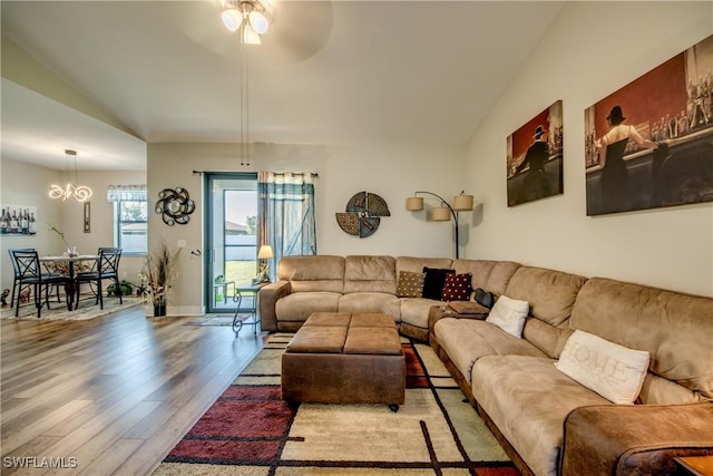 living room featuring ceiling fan, wood-type flooring, and lofted ceiling