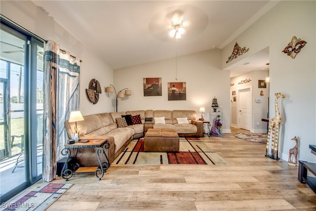 living room featuring ceiling fan, vaulted ceiling, and light wood-type flooring