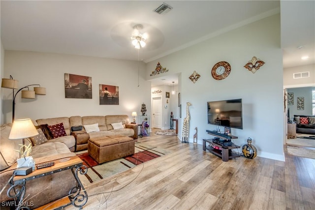 living room with ceiling fan, high vaulted ceiling, and hardwood / wood-style flooring