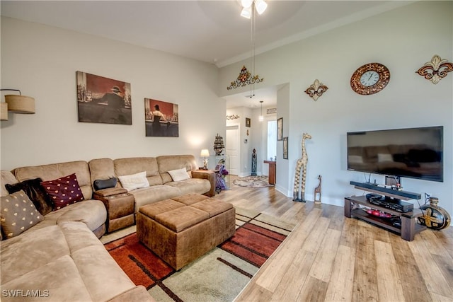 living room featuring ceiling fan and hardwood / wood-style floors