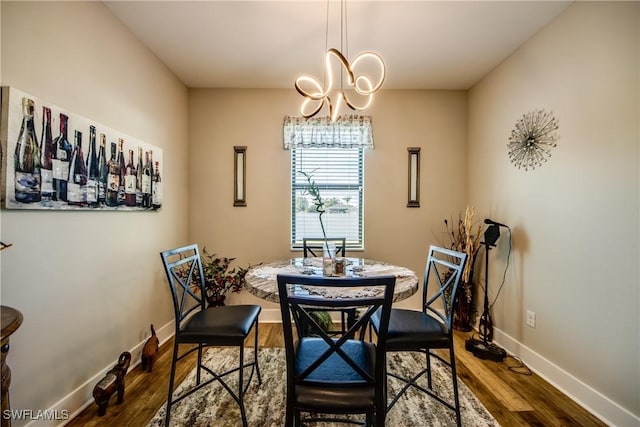 dining room with a chandelier and dark wood-type flooring