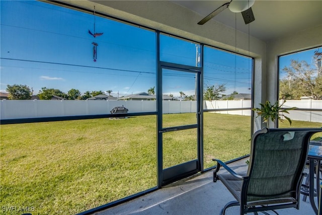 sunroom / solarium featuring ceiling fan