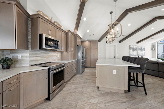 kitchen with a center island, vaulted ceiling with beams, decorative light fixtures, decorative backsplash, and appliances with stainless steel finishes