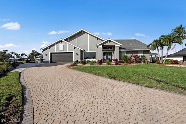 view of front of house with a garage and a front yard