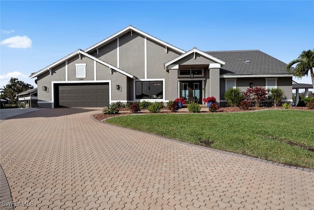 view of front of home with a front yard and a garage