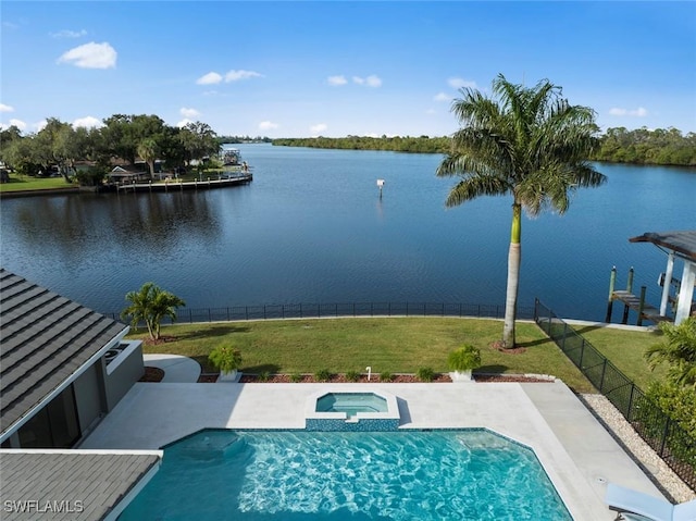 view of pool with an in ground hot tub, a yard, and a water view