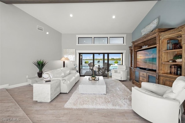 living room featuring light wood-type flooring and high vaulted ceiling