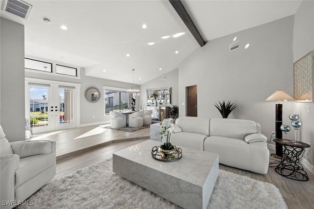 living room featuring french doors, light hardwood / wood-style flooring, beamed ceiling, high vaulted ceiling, and a notable chandelier