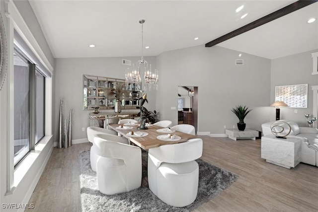 dining area with a notable chandelier, light hardwood / wood-style floors, and a wealth of natural light