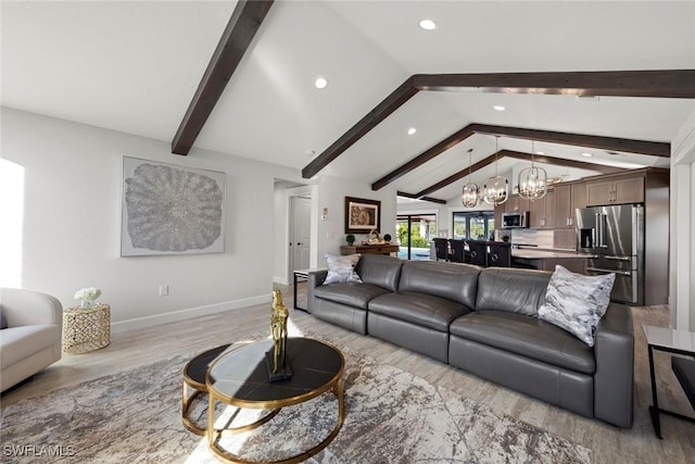 living room featuring vaulted ceiling with beams, light wood-type flooring, and a chandelier