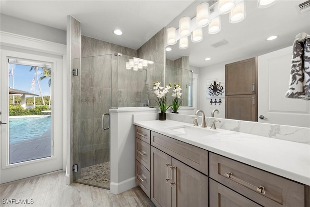 bathroom featuring vanity and a shower with shower door