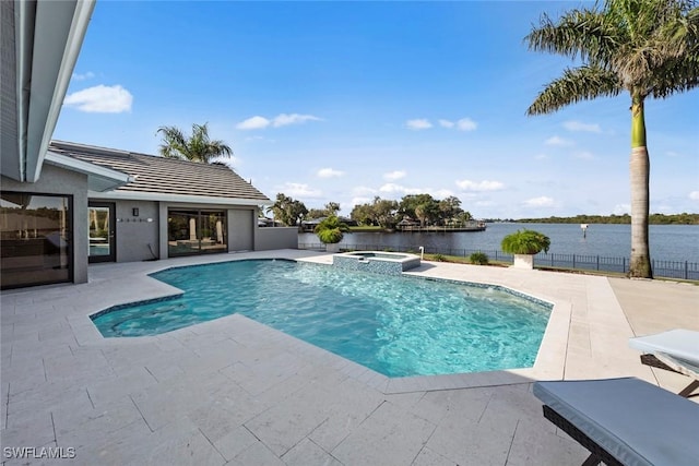 view of swimming pool featuring an in ground hot tub, a patio, and a water view