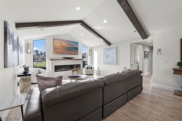 living room with light hardwood / wood-style flooring and lofted ceiling with beams