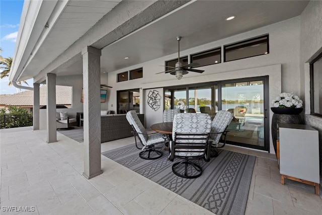 view of patio with ceiling fan and an outdoor living space