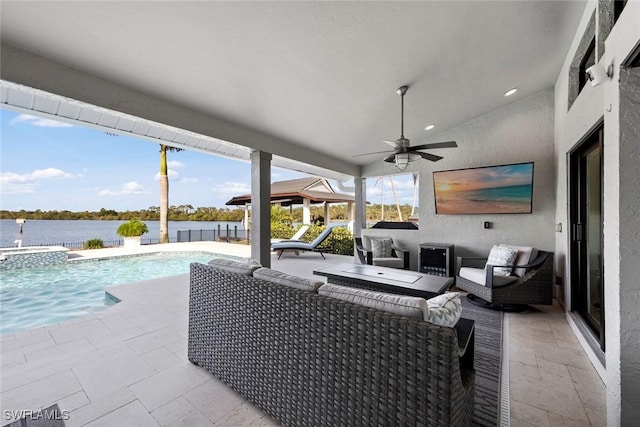 view of patio / terrace with an outdoor living space, a water view, and ceiling fan